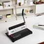 VEVOR binding machine on a white desk, lever upright, with spiral notebooks and pen in a modern office.