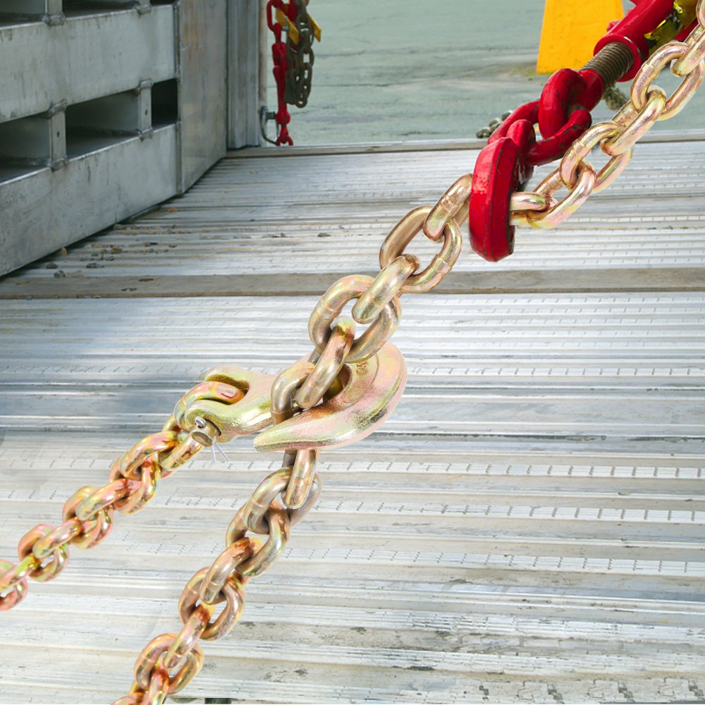 VEVOR transport binder chain securing cargo on metal truck bed with red tensioning device.