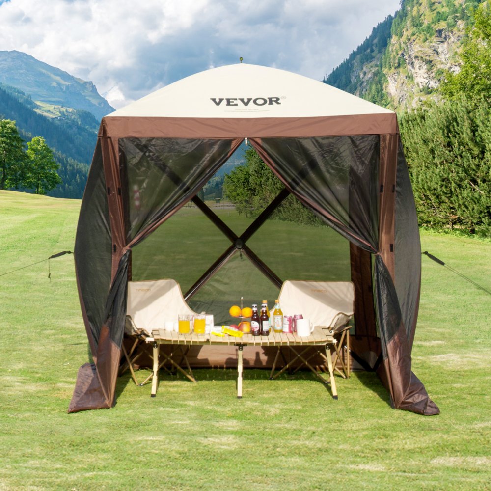 VEVOR pop-up gazebo tent with chairs and a table set up on a green lawn against a mountainous backdrop.