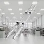VEVOR linear guide rail set in a bright, modern industrial workshop with metal racks and equipment.