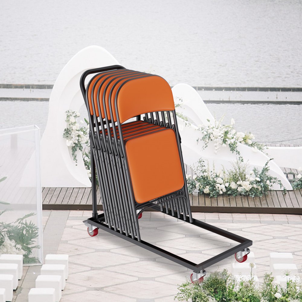 VEVOR folding chair dolly loaded with orange chairs on a patio near a lake.