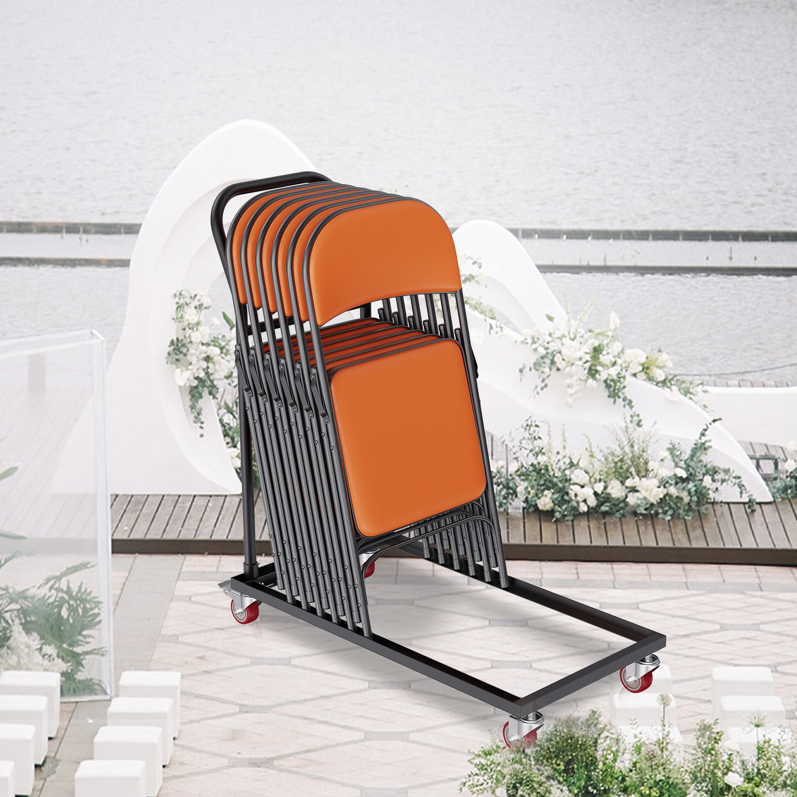 VEVOR folding chair dolly loaded with orange chairs on a patio near a lake.