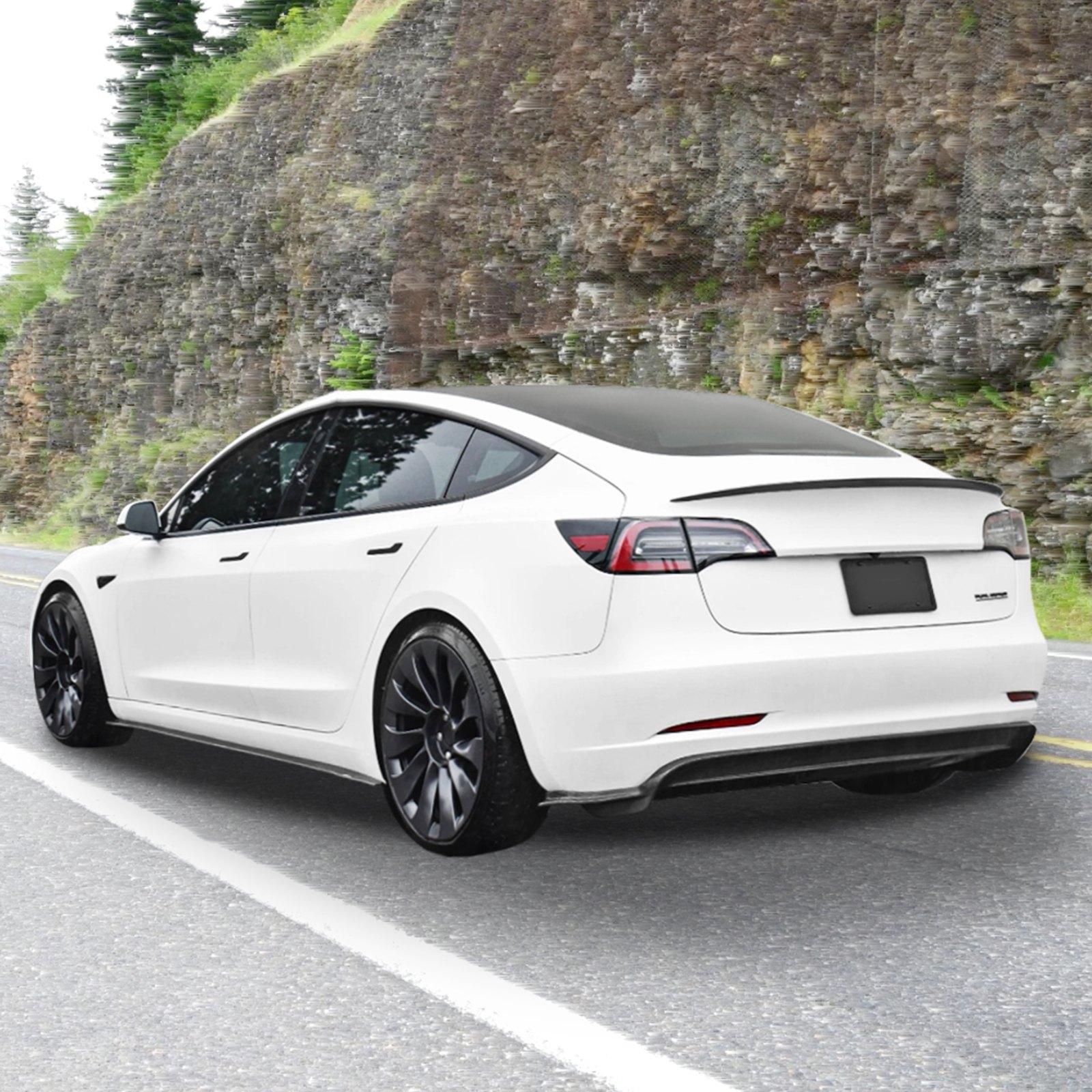 white tesla model 3 with VEVOR spoiler on mountain road.