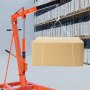 VEVOR hydraulic jack lifting a cardboard box in a warehouse with shelves filled with packages.