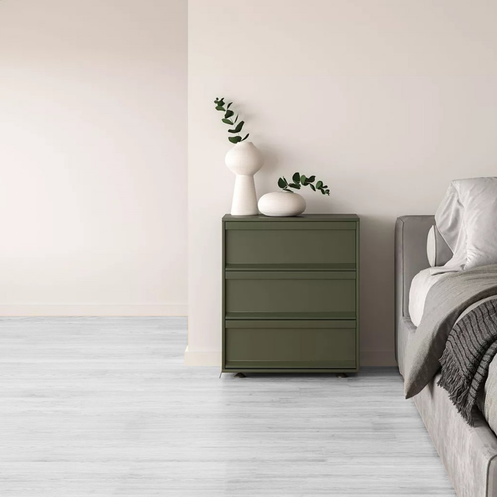 minimalist bedroom with gray bed, olive-green dresser, and white VEVOR vinyl floor tiles.