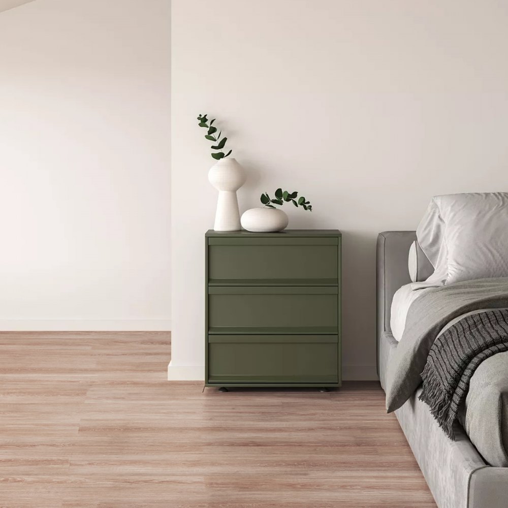 green dresser with white vases beside a bed on VEVOR self adhesive vinyl floor tiles in a minimalist bedroom.