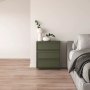 green dresser with white vases beside a bed on VEVOR self adhesive vinyl floor tiles in a minimalist bedroom.