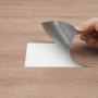 hand installing VEVOR self adhesive vinyl floor tiles on wood-patterned surface.